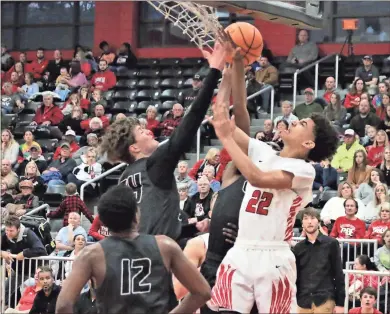  ?? Jeremy Stewart ?? Chattooga’s Jaylon Johnson (22) is fouled by Coosa’s Sam Richardson under the basket during the second half of Friday’s Region 7-AA boys’ semifinal game at Chattooga High School. The Indians won 82-66.