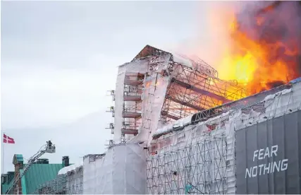  ?? MARIE ODGAARD/RITZAU SCANPIX/AFP ?? This photograph shows flames engulfing the Copenhagen’s Stock Exchange building, in Copenhagen, yesterday. PHOTO: IDA