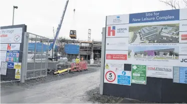  ?? PACEMAKER ?? Lieutenant Colonel Blair Mayne and (right) work under way on the new leisure centre in Newtownard­s which it is proposed be named after him