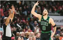  ?? CHARLES REX ARBOGAST/AP ?? Celtics’ Jayson Tatum celebrates after his 3-point basket in the second half on Thursday against the Bulls in Chicago.