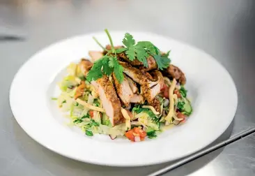  ??  ?? Grilled Thai chicken salad. When you are making this at home you can make as many changes as you want and add ingredient­s that you know will be eaten in your house.