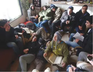  ?? (Marc Israel Sellem/The Jerusalem Post) ?? YOUNG PROTESTERS sit in a caravan singing and resting as they wait to be evacuated by police officers from the illegal outpost in Amona yesterday.