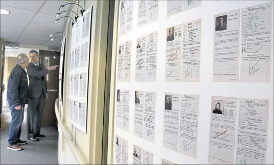  ?? Darrell Sapp photos/Post-Gazette ?? Retired Pitt archivist David Rosenberg and Jean-Dominique Le Garrec, French consul to Pittsburgh, look through the Holocaust exhibit at Temple Emanuel in Mt. Lebanon.