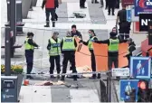  ?? JONATHAN NACKSTRAND, AFP/GETTY IMAGES ?? Swedish police work at the scene Friday. One person had been arrested in what the prime minister called a likely terrorist attack.