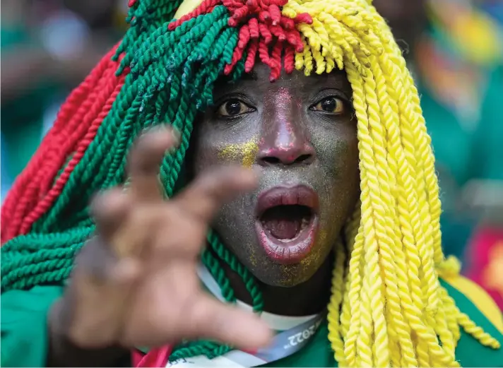  ?? ?? A Cameroon supporter cheers prior to the World Cup group G soccer match between Switzerlan­d and Cameroon, at the Al Janoub Stadium in Al Wakrah, Qatar, yesterday. Photo: Ebrahim Noroozi/AP