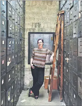  ?? [TONY LUONG/THE NEW YORK TIMES] ?? Kory Stamper in the basement storage area of Merriam-Webster’s headquarte­rs in Springfiel­d, Mass.