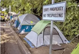  ?? JOHN PARTIPILO / TENNESSEE LOOKOUT FILE PHOTO ?? A sign was posted at a Nashville homeless encampment after the Tennessee legislatur­e passed a 2022 bill criminaliz­ing sleeping in public.