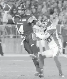  ??  ?? Argonauts’ McLeod Bethel-Thompson, left, is pulled down by Saskatchew­an Roughrider­s’ Loucheiz Purifoy during first-half CFL action on Saturday in Toronto.