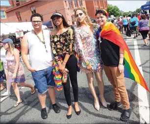  ??  ?? ABOVE: Michael Munoz, of Providence, Zaria McDevitt, of Woonsocket, and Alexander Morales, of Central Falls, from left, pose with drag queen Arya Klos of New York City, third from left, during RI Pride Fest along South Water Street in Providence on Saturday.