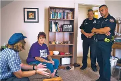  ?? TY WRIGHT/FOR THE WASHINGTON POST ?? Recovering heroin addict Twila Fair talks to Mike Bessler, left, of the Miami County Recovery Center, Brian Ross of the Troy Police Department and Greg Dilts of the Troy Fire Department, right, all members of a team to help Ohio residents struggling...