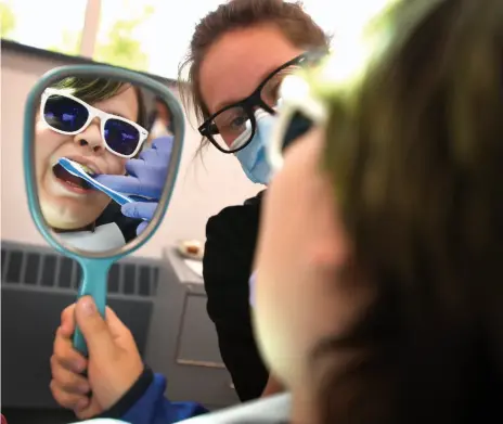  ?? CITIZEN FILE PHOTO ?? Brody Solonas, 10, a Van Bien student gets a teeth brushing lesson from a CNC Certified Dental Assistant student in May 2018. The college promotes oral health for local children through its annual Seal in a Smile program.