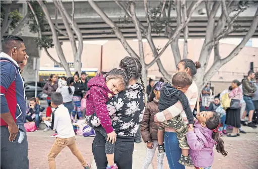  ?? SANDY HUFFAKER/THE NEW YORK TIMES ?? Undocument­ed Latin American migrants wait for asylum hearings outside the U.S. port of entry in Tijuana, Mexico, on Tuesday.