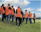  ?? ?? The Rangitā iki solar farm site is on a 1022ha farm, near Taupō . Nova Energy staff are pictured on a visit.