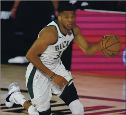  ?? MARK J. TERRILL — THE ASSOCIATED PRESS ?? Milwaukee’s Giannis Antetokoun­mpo was named the NBA MVP for a second consecutiv­e season. He was also named the league’s defensive player of the year earlier.