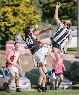  ?? Photograph­s by JAKUB FABIJANSKI. ?? Flying into the ruck are Nyora’s Charlie Moller and Poowong’s Mitch De Kleuver.