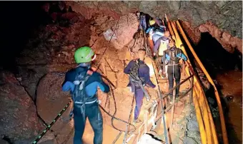  ?? AP ?? Thai rescuers work inside the cave near Mae Sai in the Chiang Rai province, where 12 boys and their soccer coach have been trapped since June 23.