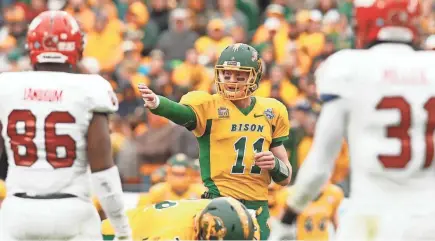  ?? PHOTOS BY TIM HEITMAN, USA TODAY SPORTS ?? One scout says of Carson Wentz (11), “He’s just different. And, obviously, he’s 6-5, 230, and can spin it like a mother.”