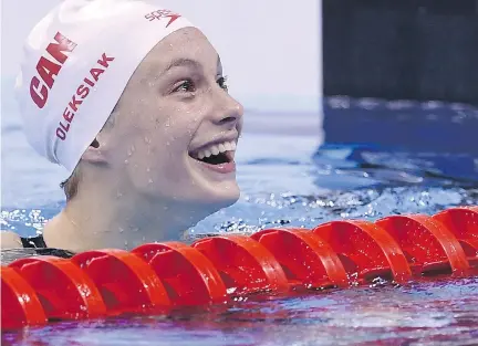  ?? GABRIEL BOUYS/AFP/GETTY IMAGES ?? Penny Oleksiak reacts after winning the women’s 100m freestyle Thursday at the Olympic Aquatics Stadium in Rio.