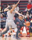  ?? JIM THOMPSON/JOURNAL ?? UNM’s Alex Lapeyroler­ie (4) and Kianna Keller, rear pressure UNLV’s Dakota Gonzalez during their game in the Pit.