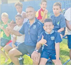  ?? Picture: SUPPLIED ?? Former Naitasiri fifteens coach Sailosi Naiteqe with some of his young rugby players in North Queensland.