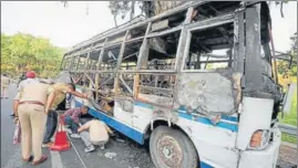  ?? PTI ?? Police personnel and forensic experts inspecting the charred remains of the bus that caught fire in Katra on Thursday.