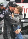  ?? Jared C. Tilton / Getty Images ?? Kyle Busch celebrates with his son Brexton in Victory Lane after winning at Texas Motor Speedway.