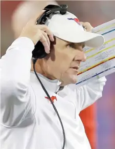  ?? AP file) (Photo by Brandon Wade, ?? Chad Morris looks on from the sidelines while coaching SMU during the first half of a game against South Florida, in Dallas. Morris will become the new coach at Arkansas.