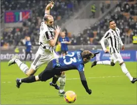  ?? Luca Bruno Associated Press ?? JUVENTUS’ GIORGIO CHIELLINI, left, challenges for the ball with Inter Milan’s Nicolo Barella during the Italian Super Cup final Jan. 12 in Milan.