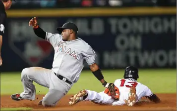  ?? John Bazemore / The Associated Press ?? Atlanta’s Pedro Ciriaco (right) is tagged out by Miami’s Adeiny Hechavarri­a as he tries to steal second base.