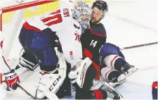  ?? GERRY BROOME/THE ASSOCIATED PRESS ?? Carolina’s Justin Williams gets cheek to cheek with Capitals goalie Braden Holtby during the Hurricanes’ Game 6 win on Monday night in Raleigh, N.C.