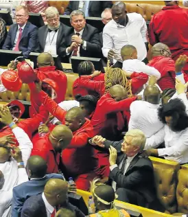  ?? /The Times ?? New normal: Security officials force out EFF members during President Jacob Zuma’s state of the nation address.