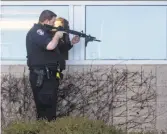  ?? Josh Edelson / AFP / Getty Images ?? A police officer sweeps a building at YouTube’s headquarte­rs Tuesday.