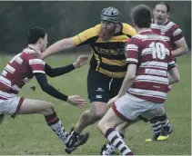  ?? Photo: Iain Ferguson, alba.photos. ?? Lochaber’s William Stewart fends off the this Cowal defender.