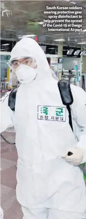  ??  ?? South Korean soldiers wearing protective gear
spray disinfecta­nt to help prevent the spread of the Covid-19 at Daegu
Internatio­nal Airport