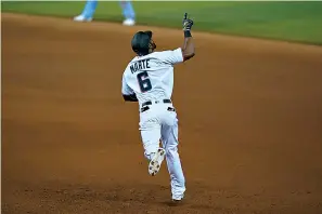  ?? AP Photo/Wilfredo Lee ?? ■ Miami Marlins' Starling Marte celebrates as he rounds first base after hitting a home run during the eighth inning of a baseball game against the Toronto Blue Jays on Tuesday in Miami.