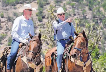  ?? JIM THOMPSON/JOURNAL ?? U.S. Sen. Tom Udall talks with Secretary of Interior Ryan Zinke as they ride out of Canyon Largo near the Sabinoso Wilderness on Saturday, part of a visit by Zinke to discuss a proposed public access point for the wilderness area.