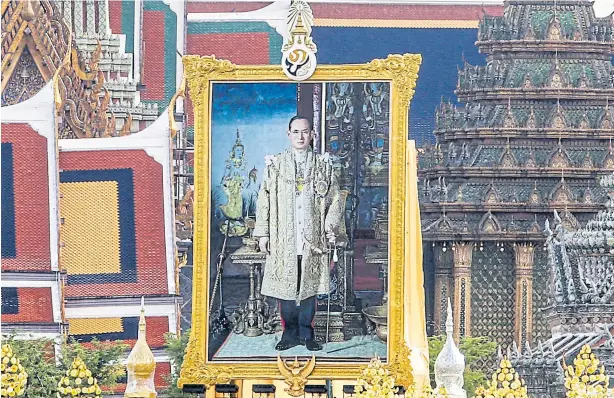  ??  ?? GONE BUT NOT FORGOTTEN: A portrait of His Majesty King Bhumibol Adulyadej The Great is erected at Sanam Luang in front of the Grand Palace as the government prepares to hold a ceremony to commemorat­e the passing of the late King today.