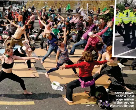  ??  ?? Karma down, dear: A mass yoga session in the road on Waterloo Bridge