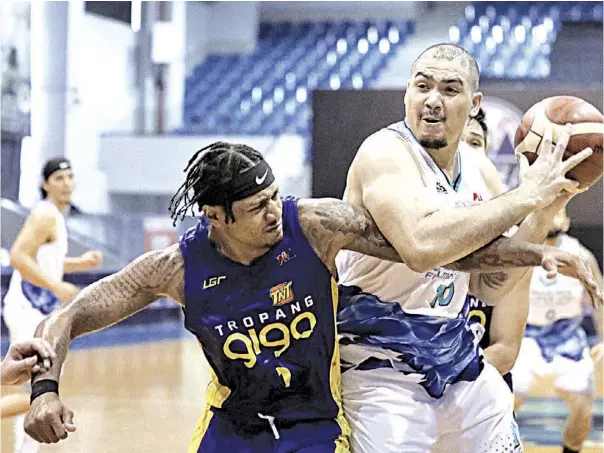  ?? PHOTOGRAPH COURTESY OF PBA ?? DAVE Marcelo of Phoenix (right) protects the ball from Ray Parks of TNT Tropang Giga during their PBA Philippine Cup game last night at the AUF Arena in Pampanga.