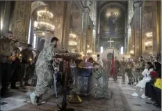  ?? AP photo ?? Volunteers of the Georgian legion pay their last respect, during the funeral ceremony for Georgian volunteer Edisher Kvaratskhe­lia killed in a battlefiel­d in St. Volodymyr Cathedral in Kyiv, Ukraine on Thursday.