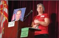  ?? DIGITAL FIRST MEDIA FILE PHOTO ?? Tammy Harkness, an organizer of the Feb. 25 town hall meeting at Phoenixvil­le High School, stands next to a photo of Congressma­n Ryan Costello, who was invited to the meeting but could not attend because of scheduling conflicts. Costello now says in...