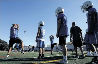  ?? Photos by Carlos Avila Gonzalez / The Chronicle ?? Varsity football players take part in non-impact tackling drills at Acalanes High School in Lafayette. A new law limits full-contact practice time, in response to alarm over head injuries suffered by young players.