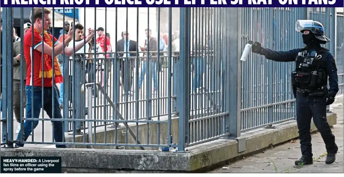  ?? ?? HEAVY-HANDED: A Liverpool fan films an officer using the spray before the game