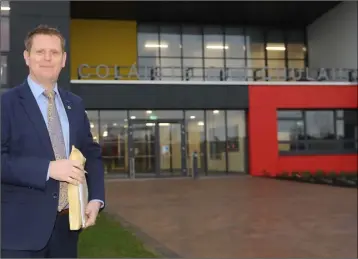  ??  ?? Principal, Tomás Sharkey at the entrance to Coláiste Chú Chulainn as they start the new term in their new complete building.