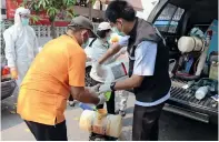  ??  ?? health personnel wearing protective clothing outside a house after family members were infected in Bangkok.