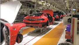  ?? Jerry Hirsch Los Angeles Times ?? THE PLANNED factory near Berlin could produce 500,000 cars a year and pose a challenge to VW, Daimler and BMW. Above, a Tesla plant in Fremont, Calif.