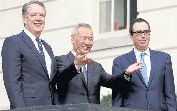  ??  ?? China’s Vice Premier Liu gestures to the media between US Trade Representa­tive Lighthizer and Treasury Secretary Mnuchin before the trade negotiatio­ns in Washington. Beijing aims to cool the row before more US tariffs kick in.