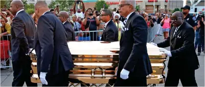  ??  ?? Gold-plated: Pall bearers carry the singer’s coffin to a museum to be put on public display