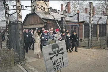  ?? Czarek Sokolowski Associated Press ?? MORE THAN 200 survivors of the Nazi death camp at Auschwitz-Birkenau join the leaders of Poland and other nations at a ceremony there Monday to commemorat­e victims and the 75th anniversar­y of its liberation.