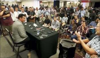  ?? CHARLES REX ARBOGAST — THE ASSOCIATED PRESS ?? Ohio State head coach Ryan Day, left, talks to reporters during the Big Ten Conference football media days Thursday in Chicago.